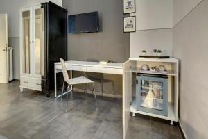 a room with a desk with a chair and a cabinet at Al Consolato in Florence