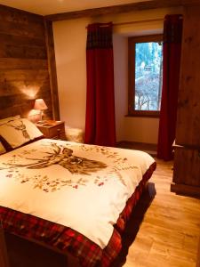 Schlafzimmer mit einem Bett und einem Fenster in der Unterkunft Chalet JJ in Sainte-Foy-Tarentaise