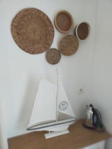 a shelf with a book and three baskets on the wall at Chambre d'hôtes Larosa in Moulis-en-Médoc