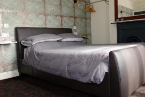 a bed with two pillows on it in a bedroom at Bedlam House in Newquay