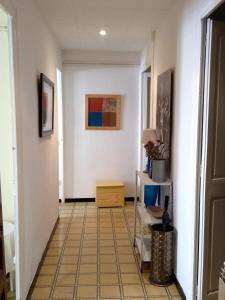 a hallway with white walls and a yellow tile floor at Can Bonshoms in Ribes de Freser