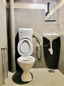 a bathroom with a toilet and a sink at Highway Times Inn Hotel in Ipoh