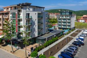 an aerial view of a building with cars parked in a parking lot at Sveti Dimitar Hotel in Primorsko