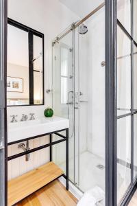 a bathroom with a sink and a shower at Jardins da Muralha Apartments by DA'HOME in Porto