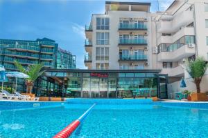 a swimming pool in front of a building at Sveti Dimitar Hotel in Primorsko