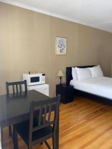 um quarto com uma cama, uma mesa e um micro-ondas em Reynolds House inn em Roscoe