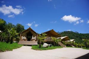 a resort with a gazebo with chairs and trees at Glamping Can Bora Lodges in Las Serras