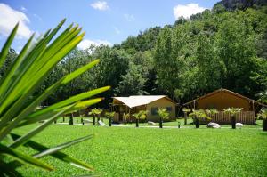 Blick auf einen Garten mit einem Haus und Bäumen in der Unterkunft Can Bora Lodges in Las Serras