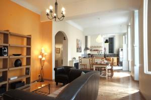 a living room with a couch and a dining room at Ze Perfect Place - Spacieux appartement - Cours Saleya - 2 CHB - 2 SDB - AC in Nice