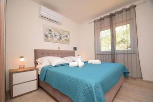 Postel nebo postele na pokoji v ubytování VILLA APARTMENTS FILIP