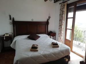 a bedroom with a bed and a dresser at Hotel Velad in Vélez Blanco