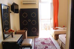 a room with a bed, a table and a window at City View Hotel in Cairo