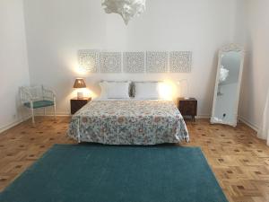 
a bedroom with a bed and a dresser at Formosa Guest House in Tavira
