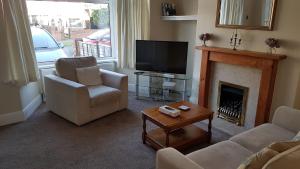 a living room with a fireplace and a television at Beverley East Townhouse Free Parking in Beverley