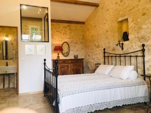a bedroom with a bed and a mirror at Chateau le Truch in Montussan