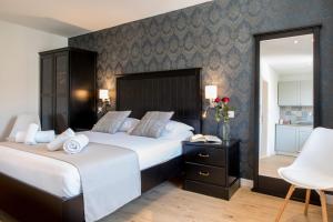 a bedroom with two beds and a table with a phone at Wind Rose Split in Split