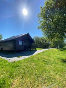 a building with the sun shining on top of it at Saltstraumen Fjordhytter in Knapplund +13 photos