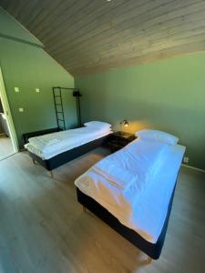 
En eller flere senger på et rom på Saltstraumen Hotels Hytter
