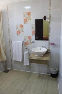 a bathroom with a toilet, sink, and mirror at City View Hotel in Cairo