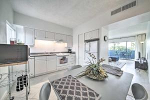 a kitchen with white cabinets and a table and chairs at Modern City Condo Close to Downtown Phoenix! in Phoenix