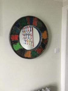 a plate on a wall with a picture ofttenham at Bedlam House in Newquay
