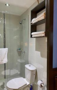 y baño con aseo y ducha acristalada. en Apartaestudio El Lugar Ideal Cra. 62 #74-143., en Barranquilla