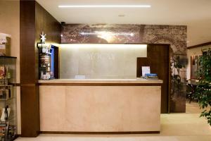 a lobby of a hotel with a reception counter at Hotel Mogay in Chantada