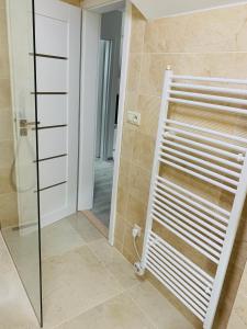 a bathroom with a shower and a glass door at Apartmán Paseky in Terchová