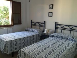 Postel nebo postele na pokoji v ubytování Villa Catalá