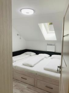 A bed or beds in a room at Apartmán Paseky
