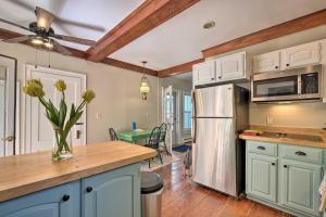 uma cozinha com um frigorífico de aço inoxidável e uma mesa em Bright Lake Winnipesaukee Home - Walk to Town em Wolfeboro
