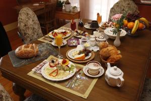 a table with a breakfast of food and orange juice at À Amour et Amitié in Magog-Orford