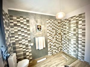 a bathroom with a toilet and a glass shower at SaraDa Boutique Luxury Apartment in Deva +44 photos