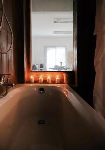 a bathroom with a bath tub with candles in it at Sailing House on the beach 16 persons in Athens
