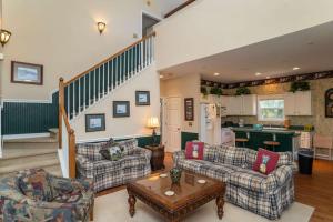 a living room with two couches and a kitchen at Lloyd's Lodge at Davis Love Dr in Fripp Island