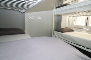 A bed or beds in a room at Madrid Downtown Hostel