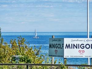 a sailboat in the ocean with a sign in front of it at 4 person holiday home in Allinge in Allinge