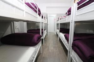 A bed or beds in a room at Madrid Downtown Hostel