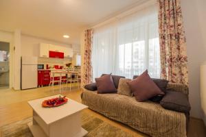 a living room with a couch and a table at Deluxe Suite Coresi in Braşov