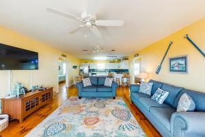 a living room with a couch and a tv at Two Views in Dauphin Island