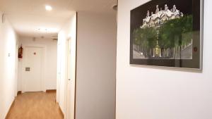 a hallway with a painting hanging on a wall at Hostal la Palmera in Barcelona