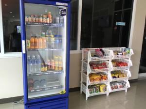 a vending machine filled with drinks in a store at Boonbundal Hotel in Roi Et