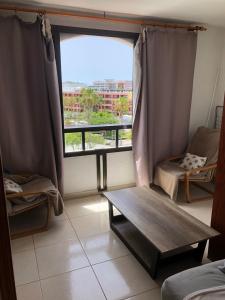 a living room with a table and a window at Parque Santiago II Tenerife in Arona +28 photos