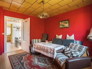 a red room with a bed and a couch at Alluring Holiday Home in Meisdorf with Garden in Meisdorf