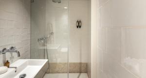 bagno bianco con doccia e lavandino di Cozy Lisbon Alfama a Lisbona