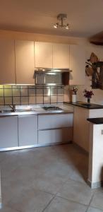 uma grande cozinha com armários e electrodomésticos brancos em Casa Elicriso em Porto Vecchio