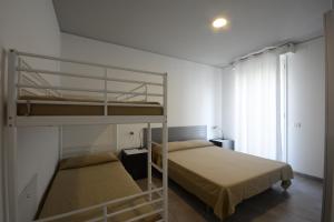 Ένα ή περισσότερα κρεβάτια σε δωμάτιο στο Graziella Residence Appartamenti