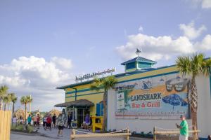 a seafood restaurant with palm trees in front of a building at Margaritaville Lake Resort, Lake Conroe in Montgomery