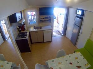 a small kitchen with a stove and a sink at L europe in Vic-la-Gardiole