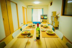a dining room table with a bottle of wine on it at 615-13 Higashiboricho, which descends from Kamicho - Vacation STAY 83236 in Kyoto